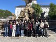 Group photo of scholarship holder standing in front of a statue in Salzburg