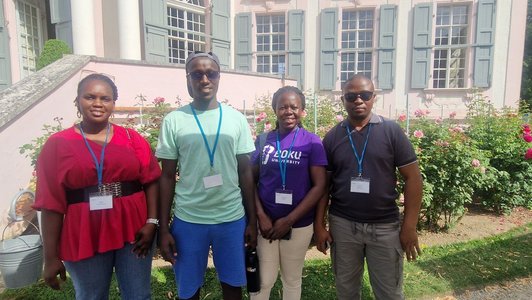 Scholars standing outside and looking at the camera