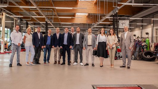 Gruppenfoto von Menschen im Autowerkstatt.